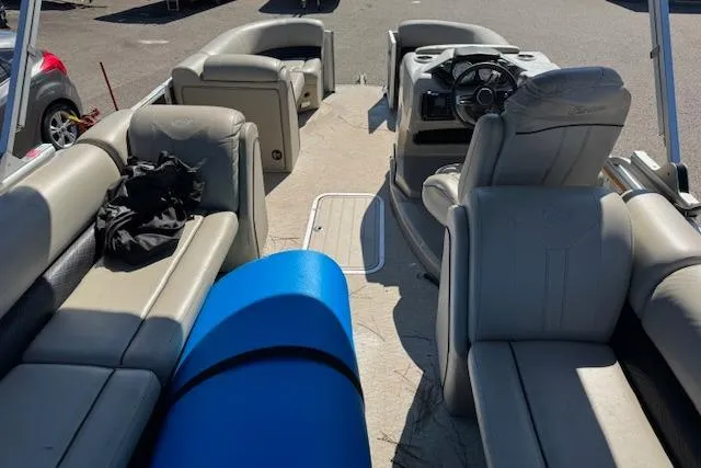 Slide: The Image of 2019 Barletta E22Q SS pontoon boat interior with seating and steering console. - 7