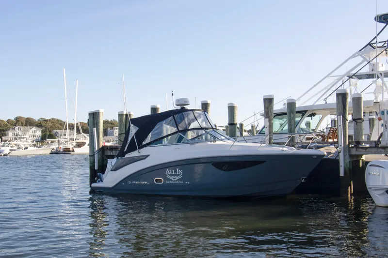 The Image of 2020 Regal 26 XO boat docked at a marina, surrounded by calm waters. - 0