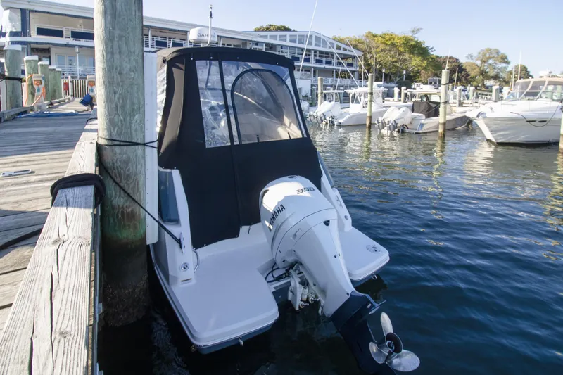 Slide: The Image of 2020 Regal 26 XO boat docked at marina with Yamaha outboard motor. - 13