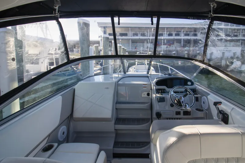 Slide: The Image of 2020 Regal 26 XO boat interior with modern helm and seating at a marina. - 6