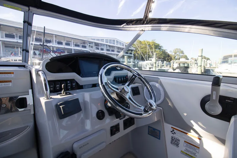 Slide: The Image of Cockpit view of 2020 Regal 26 XO boat with steering wheel and controls. - 7