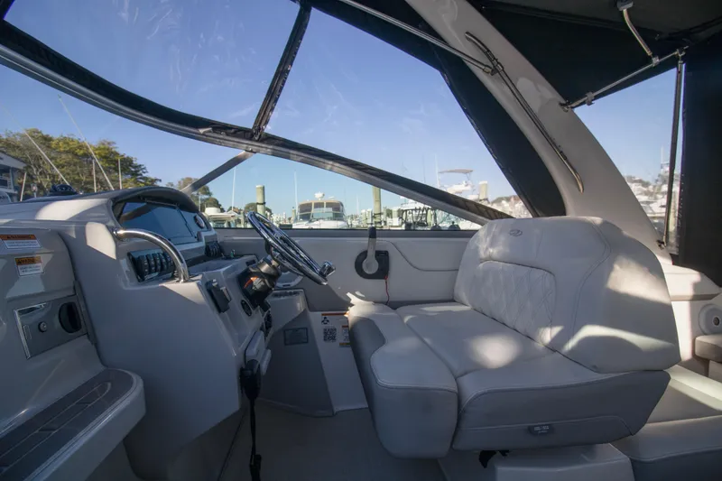 Slide: The Image of 2020 Regal 26 XO boat interior with steering wheel and seating area. - 8