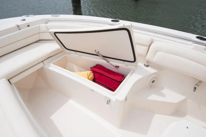 Slide: The Image of Manufacturer Provided Image: Grady-White Fisherman 236 2022 boat storage compartment with open lid and stored items. - 12