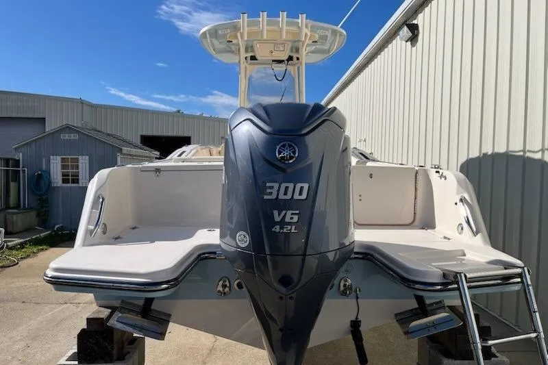 Slide: The Image of 2022 Grady-White Fisherman 236 boat with Yamaha 300 V6 engine, docked outdoors. - 2