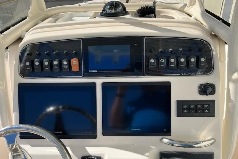 Slide: The Image of 2022 Grady-White Fisherman 236 dashboard with Garmin displays and control panel. - 4