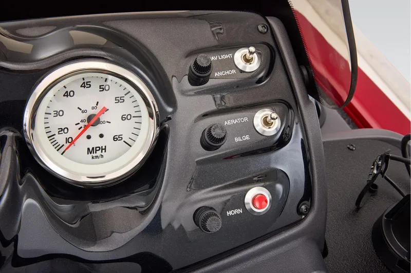 Slide: The Image of Manufacturer Provided Image: Dashboard of 2026 Tracker Super Guide V-16 SC with speedometer and control switches. - 18