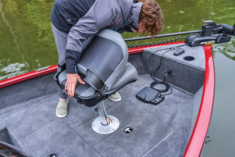 Slide: The Image of Manufacturer Provided Image: Person adjusting seat on 2026 Tracker Super Guide V-16 SC boat deck. - 34