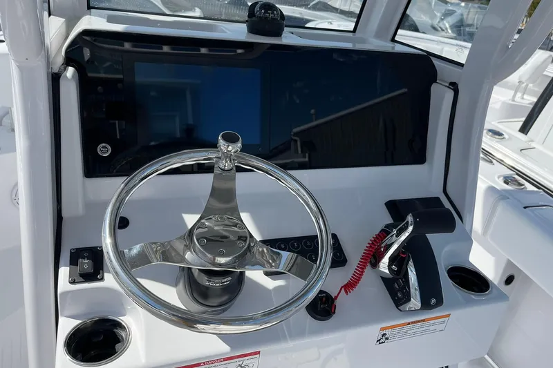 Slide: The Image of Steering console of 2026 Sportsman Heritage 231 Center Console boat, featuring modern controls. - 12