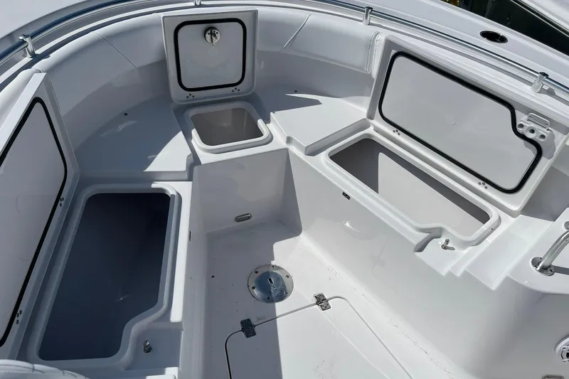 Slide: The Image of 2026 Sportsman Heritage 231 Center Console boat interior with open storage compartments. - 17