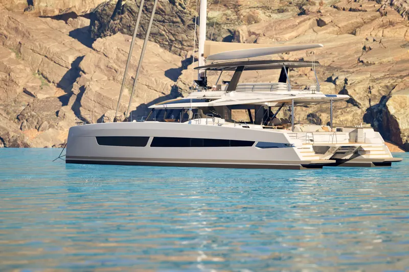 Slide: The Image of Luxury Fountaine Pajot 70 S catamaran, 2027 model, sailing near rocky coastline. - 5