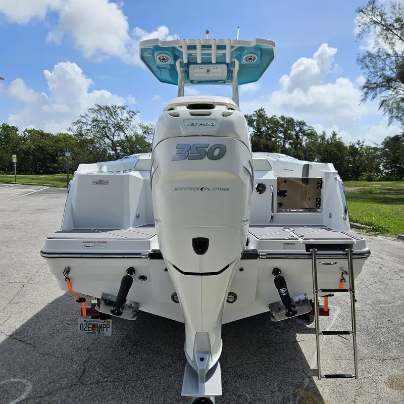 Slide: The Image of 2019 Blackfin 222 CC boat with a 350 horsepower engine, parked outdoors. - 1