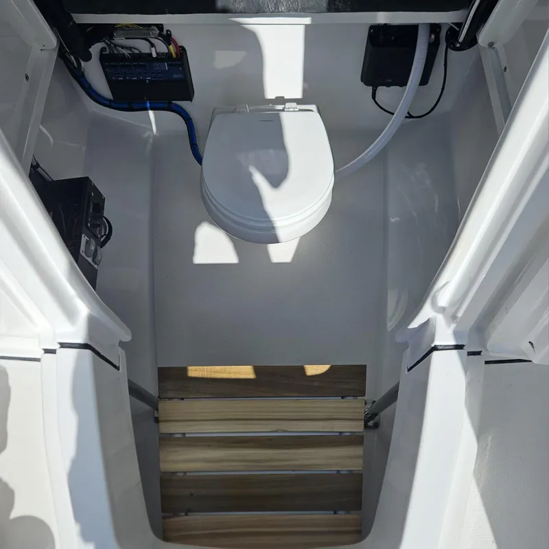 Slide: The Image of 2019 Blackfin 222 CC boat interior with marine toilet and equipment. - 11