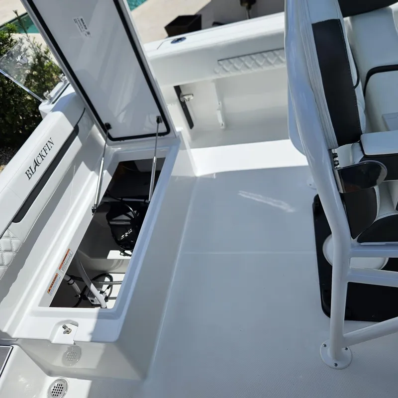 Slide: The Image of 2019 Blackfin 222 CC boat interior with open storage compartment and seating. - 12