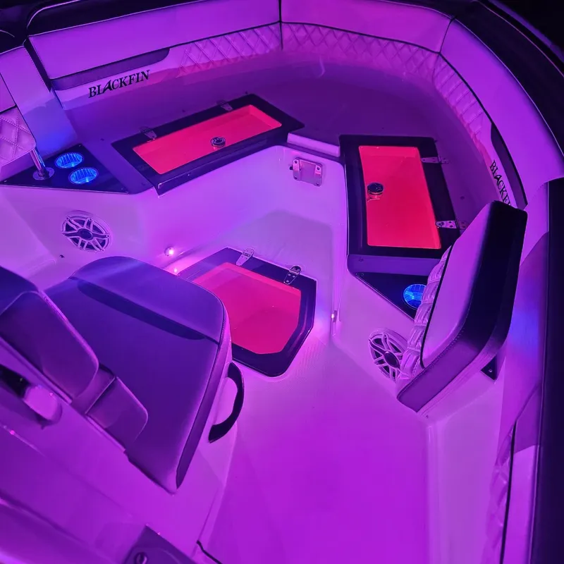 Slide: The Image of 2019 Blackfin 222 CC boat interior with vibrant purple LED lighting. - 3
