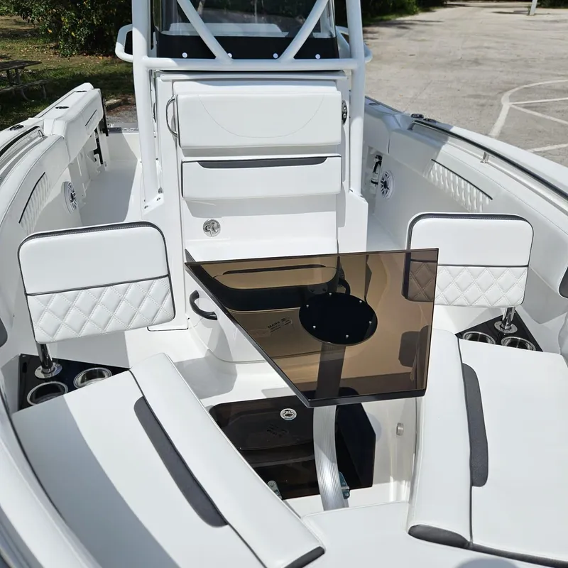 Slide: The Image of 2019 Blackfin 222 CC boat interior with seating and table, showcasing modern design and comfort. - 8