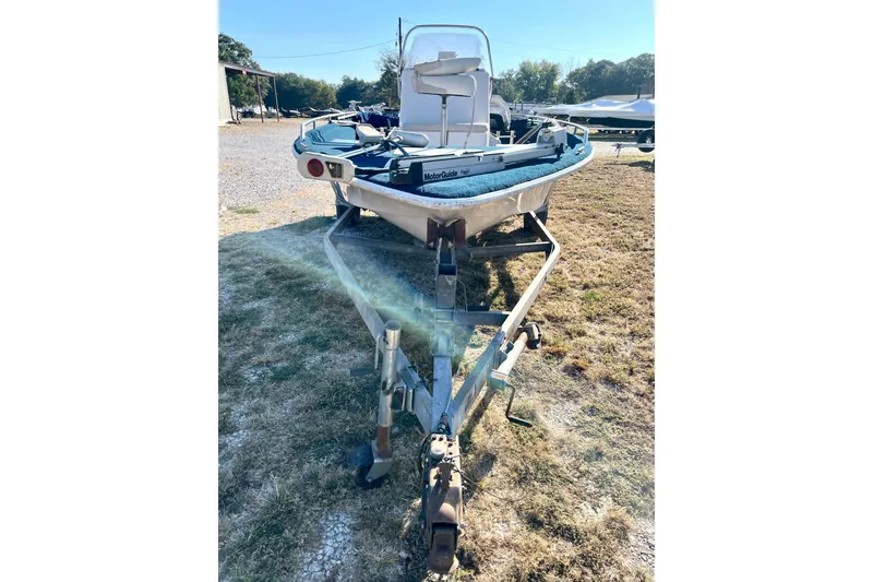 Slide: The Image of 1997 Ebbtide 190 SV boat on trailer, parked outdoors on grass. - 2