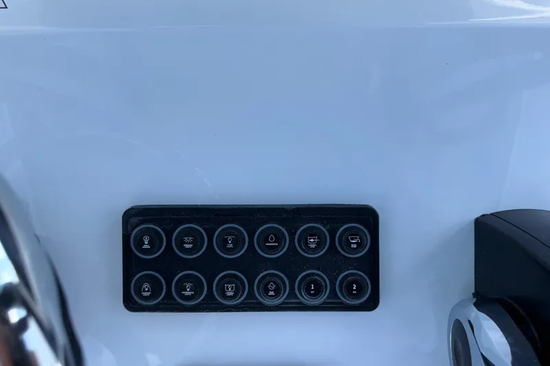 Slide: The Image of Control panel on 2026 Sportsman Open 232 Center Console boat dashboard. - 10