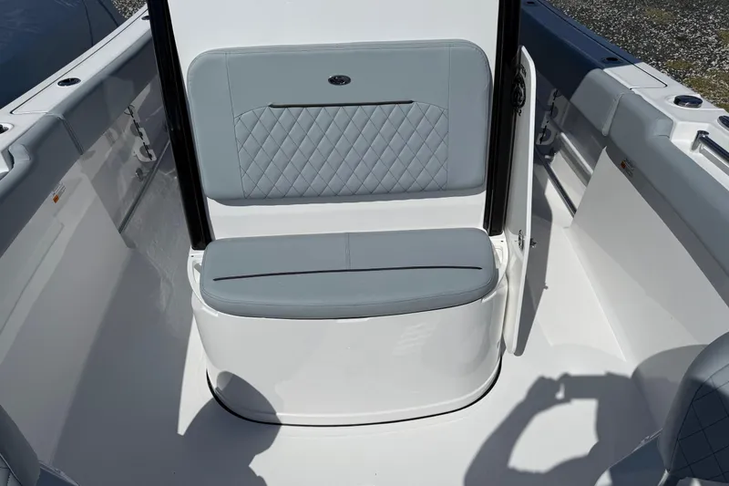 Slide: The Image of 2026 Sportsman Open 232 Center Console boat interior with cushioned seating and sleek design. - 13