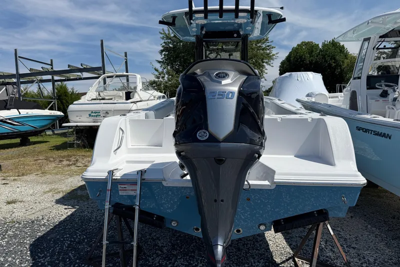 Slide: The Image of 2026 Sportsman Open 232 Center Console boat with powerful 250 engine, displayed outdoors. - 3