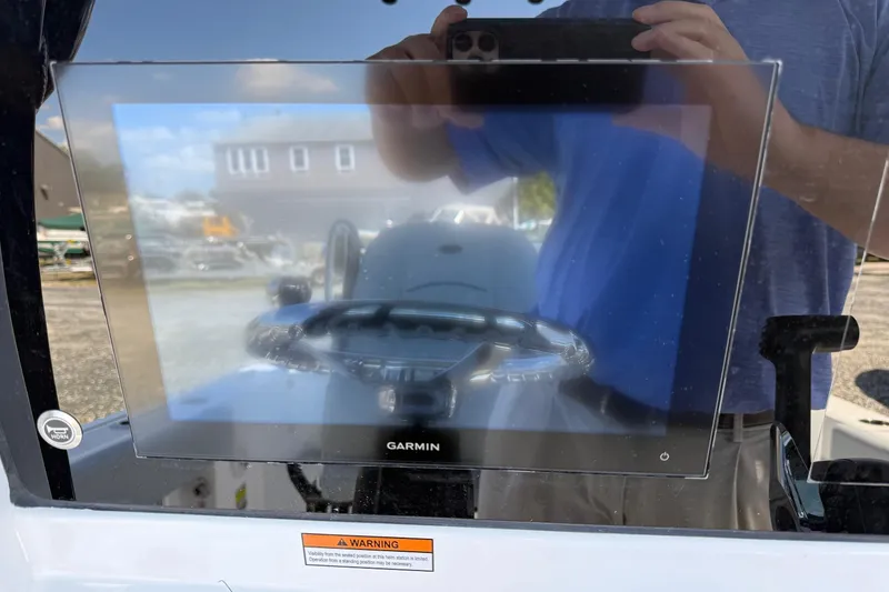 Slide: The Image of 2026 Sportsman Open 232 Center Console with Garmin display and steering wheel reflection. - 9