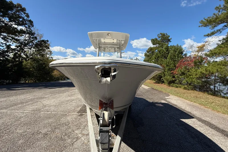 Slide: The Image of 2018 Sea Fox 248 Commander boat on trailer, surrounded by trees and blue sky. - 19