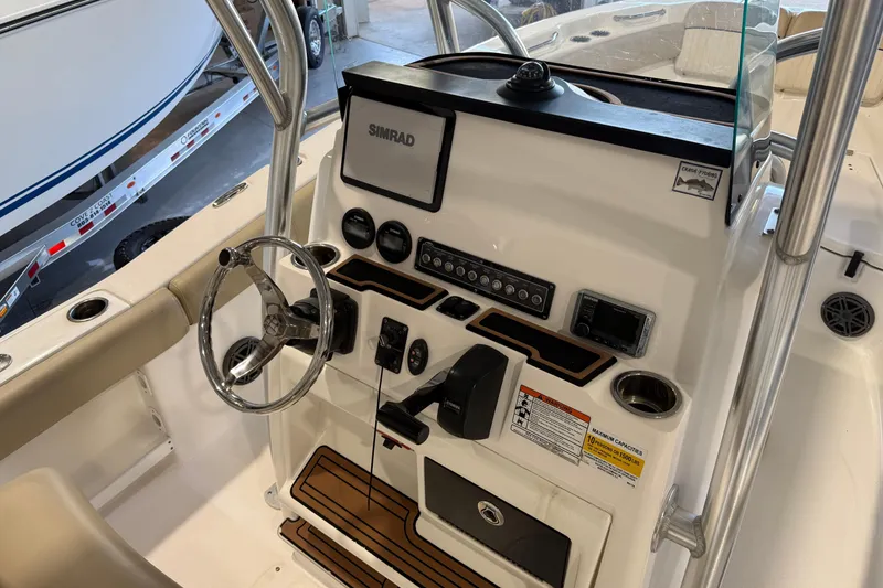 Slide: The Image of 2018 Sea Fox 248 Commander boat dashboard with steering wheel and navigation controls. - 21