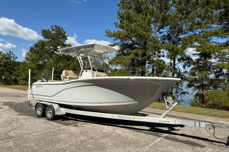 Slide: The Image of 2018 Sea Fox 248 Commander boat on trailer, parked outdoors near trees. - 3