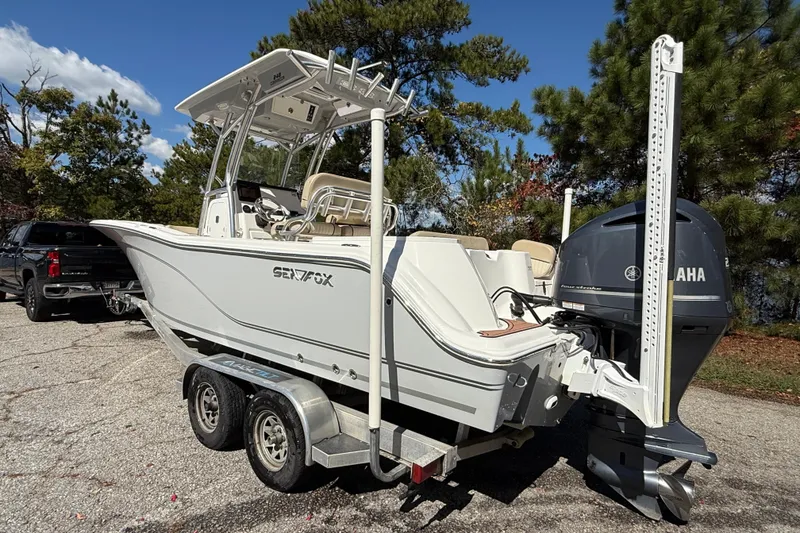 Slide: The Image of 2018 Sea Fox 248 Commander boat on trailer, parked near trees and lake. - 4