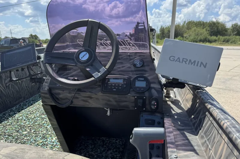 Slide: The Image of 2022 Alweld 2270 boat dashboard with Garmin navigation system and steering wheel. - 13