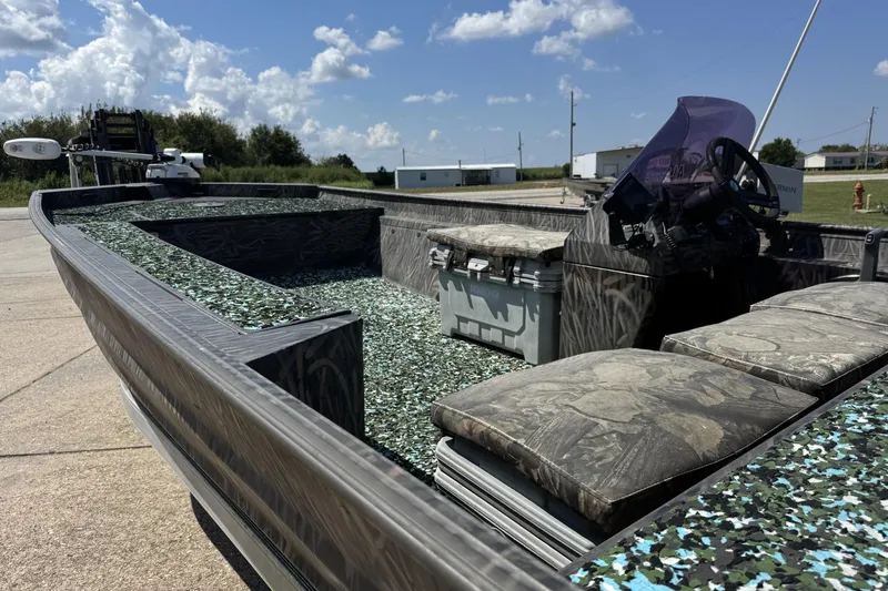 Slide: The Image of 2022 Alweld 2270 Large Flat Bottom boat with camo seats and console, parked outdoors. - 2