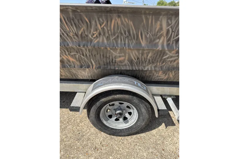 Slide: The Image of 2022 Alweld 2270 Large Flat Bottom boat trailer with camo design and visible wheel. - 9