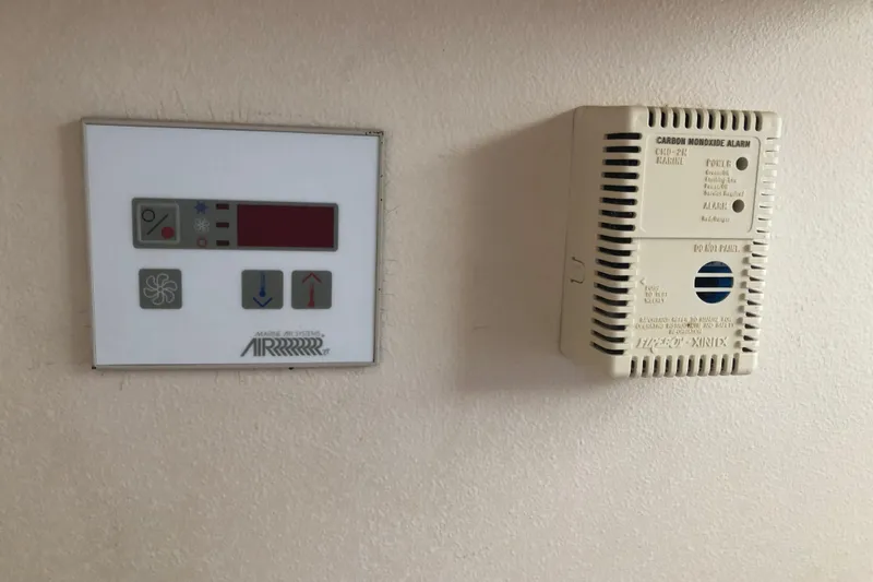 Slide: The Image of Control panel and carbon monoxide alarm on 1999 Mainship 31 Sedan Bridge yacht. - 10
