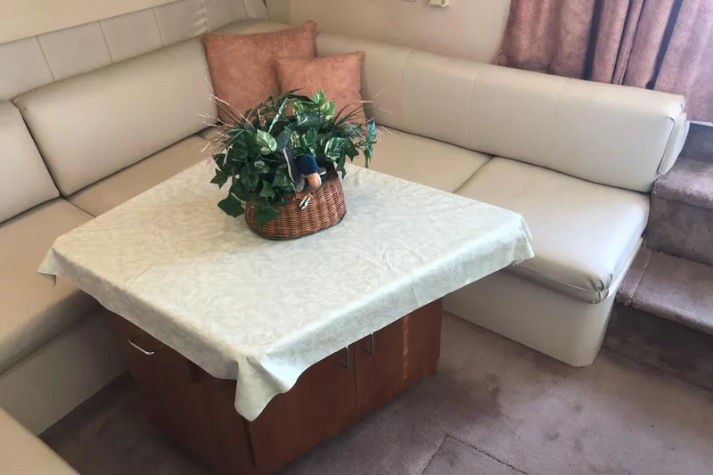 Slide: The Image of Interior of 1999 Mainship 31 Sedan Bridge with cozy seating and table. - 11