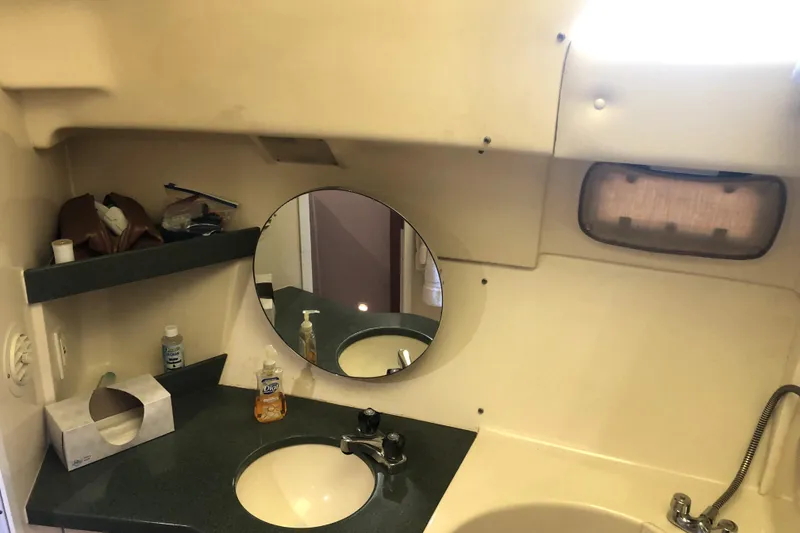 Slide: The Image of Bathroom interior of 1999 Mainship 31 Sedan Bridge with sink and mirror. - 15