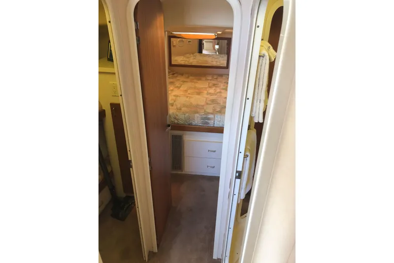 Slide: The Image of 1999 Mainship 31 Sedan Bridge interior cabin with bed and storage drawers. - 19