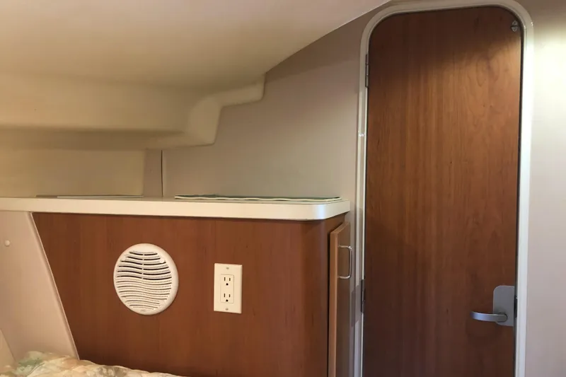 Slide: The Image of Interior of 1999 Mainship 31 Sedan Bridge with wood paneling and door. - 23