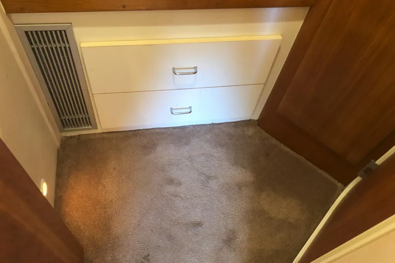 Slide: The Image of Interior of 1999 Mainship 31 Sedan Bridge with carpet, drawers, and vent. - 24