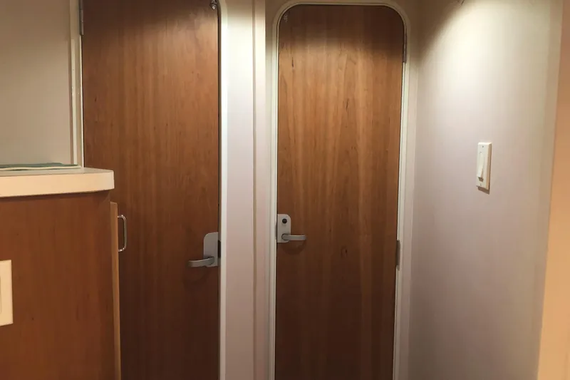 Slide: The Image of Interior of 1999 Mainship 31 Sedan Bridge with wooden doors and modern handles. - 25