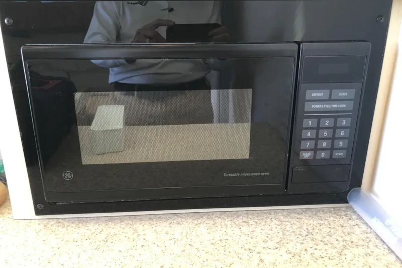 Slide: The Image of Built-in GE microwave on Mainship 31 Sedan Bridge, 1999 model, with digital keypad. - 33