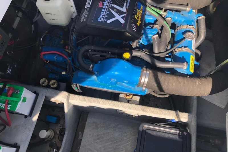 Slide: The Image of 1999 Mainship 31 Sedan Bridge engine compartment with Crusader engine and battery setup. - 42