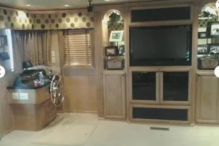 Slide: The Image of 2007 Sumerset Steelaway interior with helm, TV, and wood cabinetry. - 13
