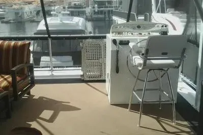 Slide: The Image of 2007 Sumerset Steelaway houseboat interior with helm, chair, and marina view. - 4