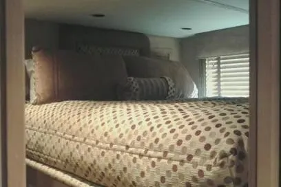 Slide: The Image of Cozy bedroom interior in 2007 Sumerset Steelaway houseboat with patterned bedding and soft lighting. - 8