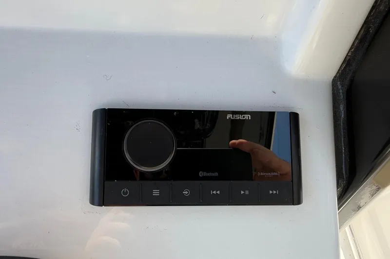 Slide: The Image of Fusion audio control panel on 2026 Sportsman Open 232 Center Console boat. - 10