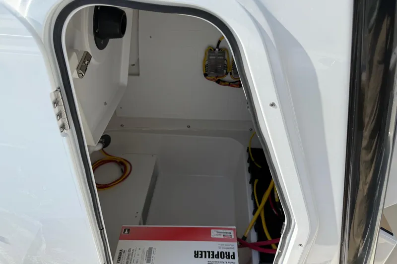 Slide: The Image of Open storage compartment in 2026 Sportsman Open 232 Center Console boat. - 11