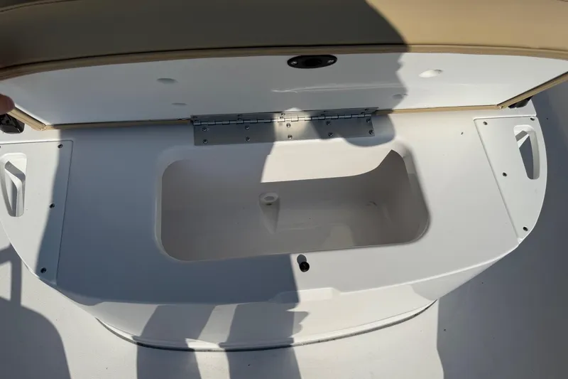 Slide: The Image of Open storage compartment on 2026 Sportsman Open 232 Center Console boat. - 13