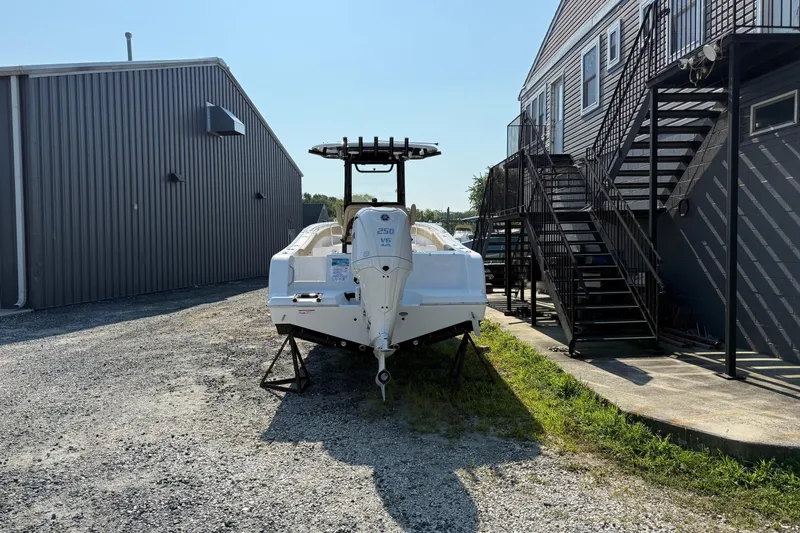 Slide: The Image of 2026 Sportsman Open 232 Center Console boat on stands near industrial building. - 4