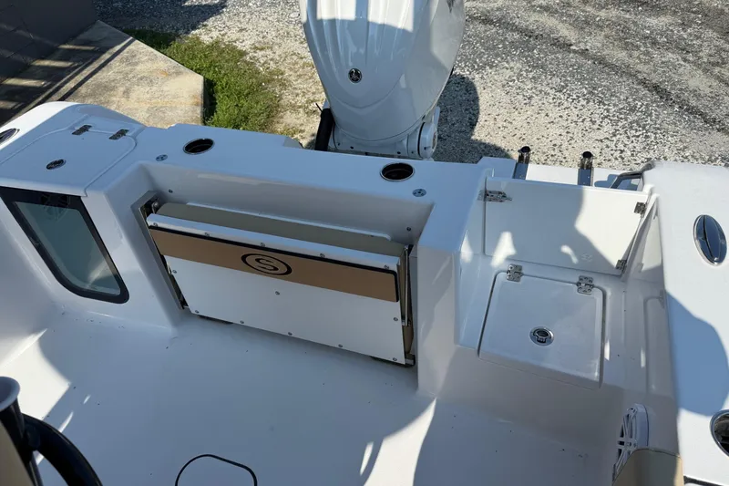 Slide: The Image of 2026 Sportsman Open 232 Center Console boat interior with storage compartments and motor. - 6