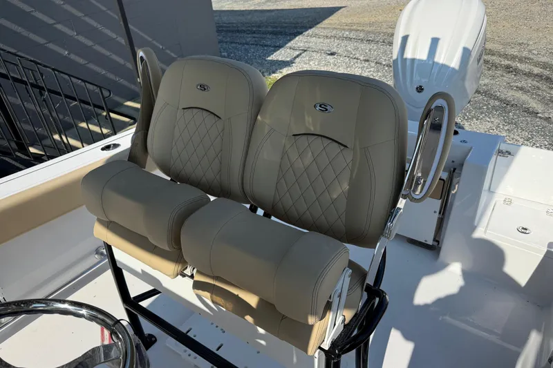 Slide: The Image of 2026 Sportsman Open 232 Center Console boat with dual cushioned seats and steering wheel. - 7