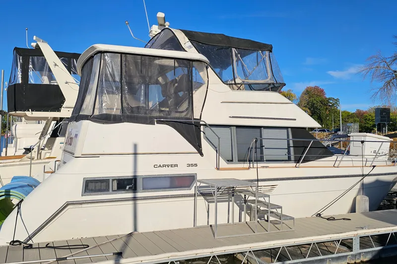 Slide: The Image of 1995 Carver 355 Aft Cabin Motor Yacht docked at marina, side view. - 2